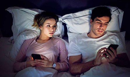 Couples on Mobile in Bed