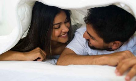 Couples under blanket