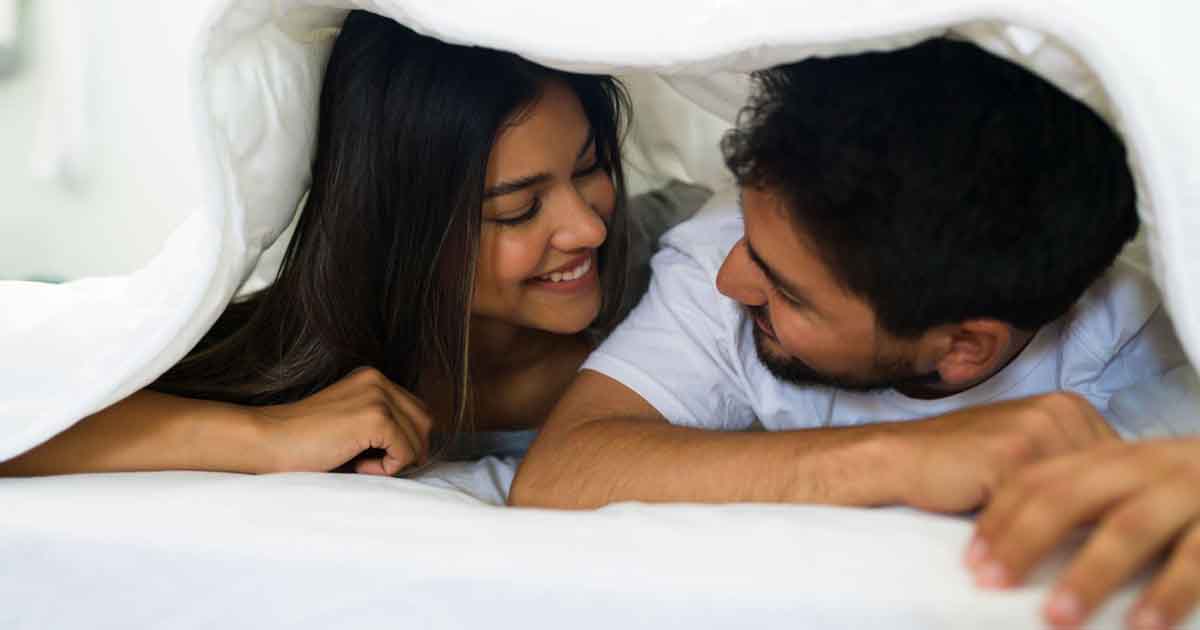 Couples under blanket