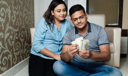 Indian couple holding currency
