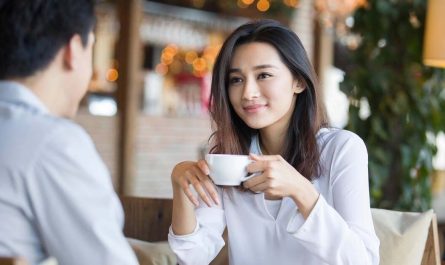 Young woman and man talking in cafe